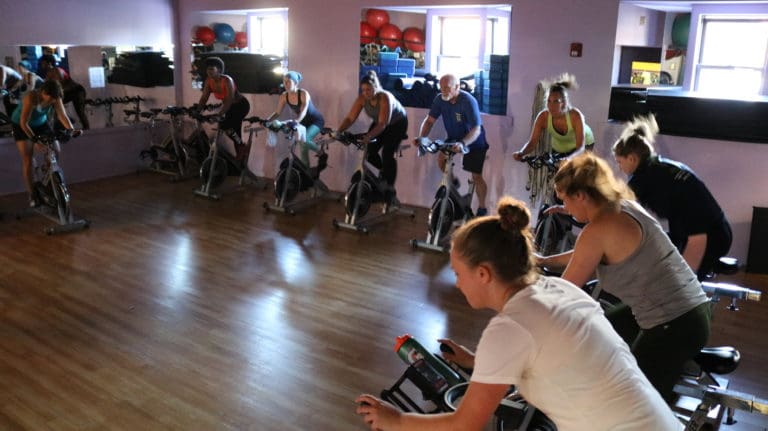Spin class riding together at Mike's Fitness JP in Jamaica Plain
