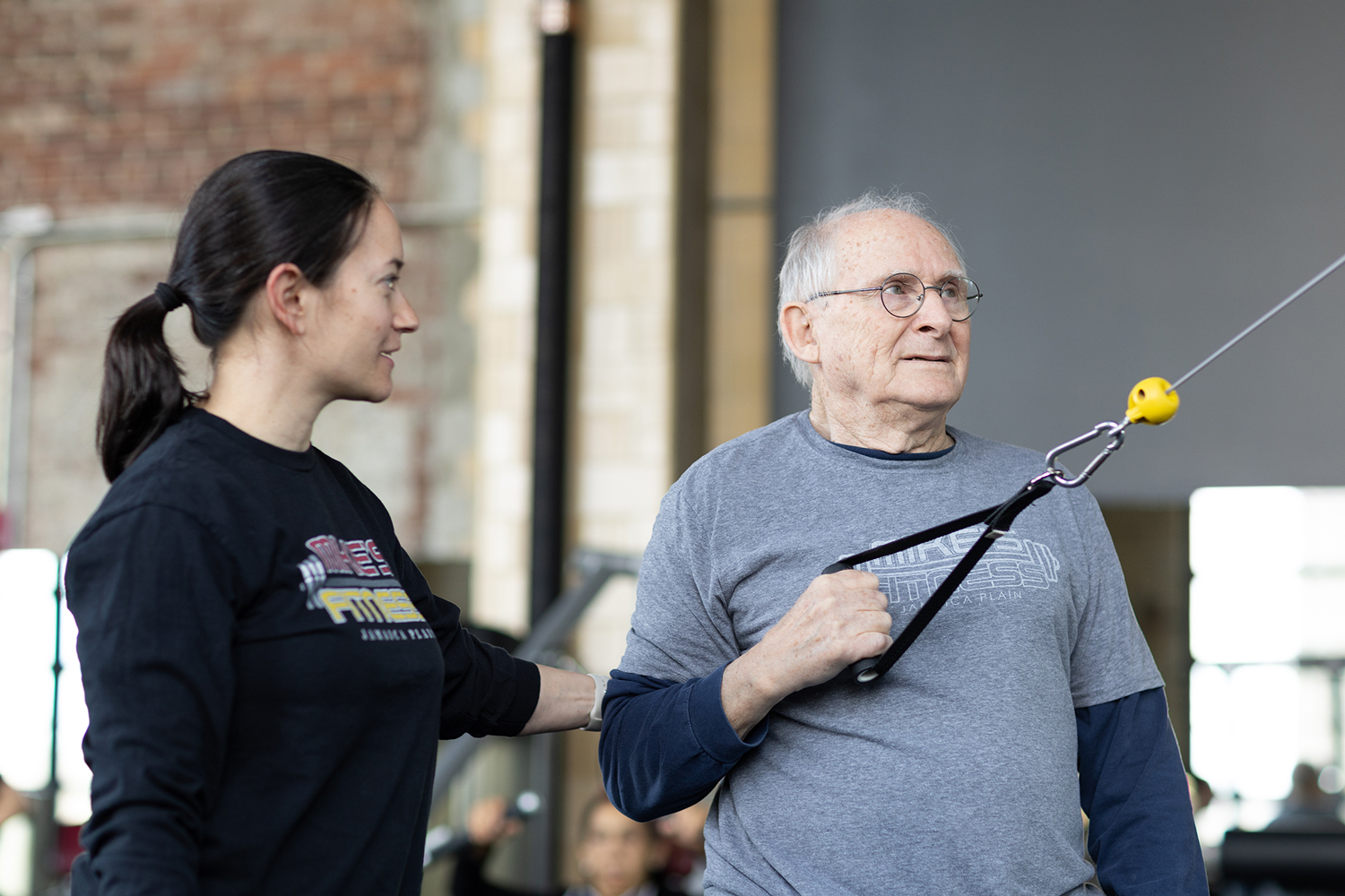 Certified personal trainer working with a client in Jamaica Plain gym